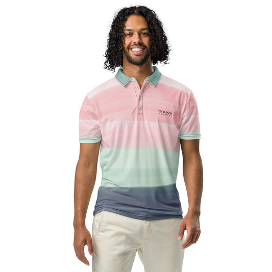 Man wearing polo shirt with design resembling watercolor stripes. Main colors are light-green and pink.