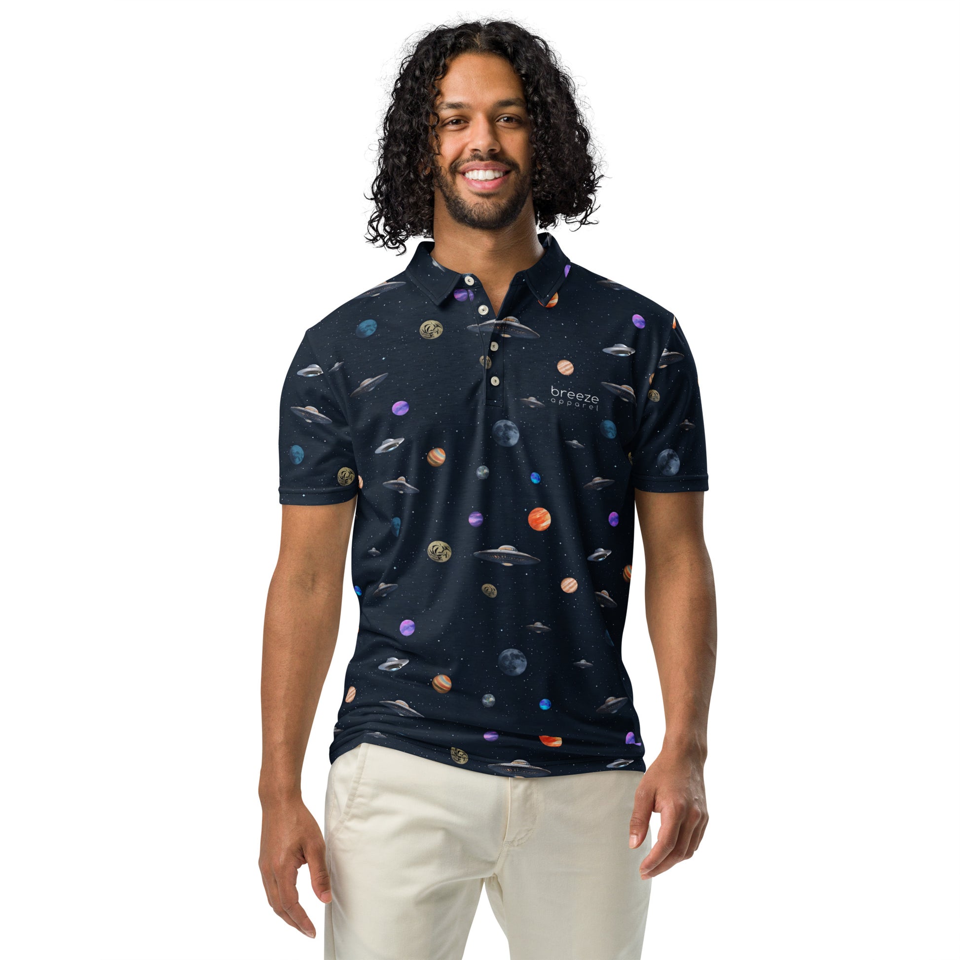 Man wearing polo shirt with pattern of UFOs and planets in space.