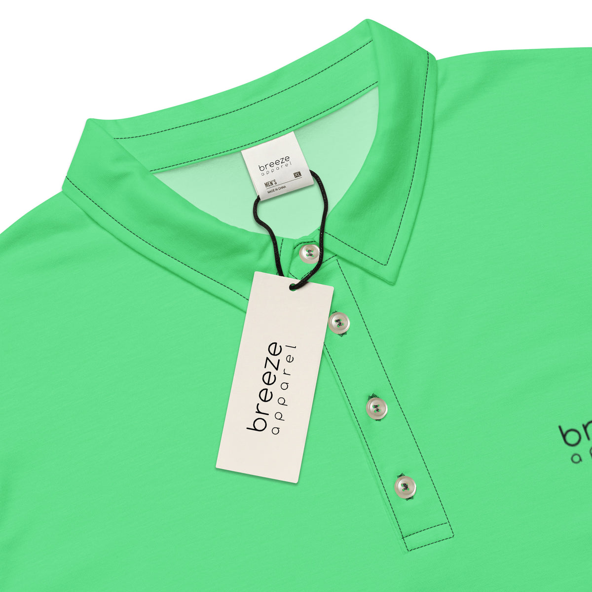 Close-up view of collar of green polo shirt with 'breeze apparel' in black over heart and on tags.