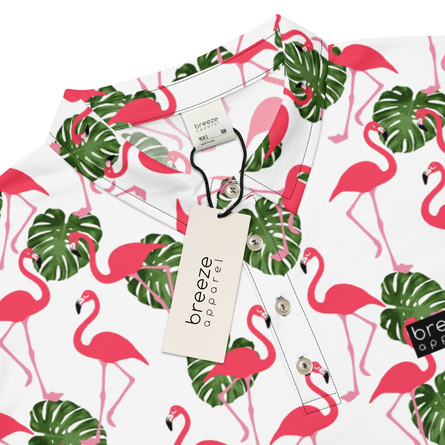 Polo with pattern of pink flamingos and green palm leaves set on a white background. Sleeves are pink.