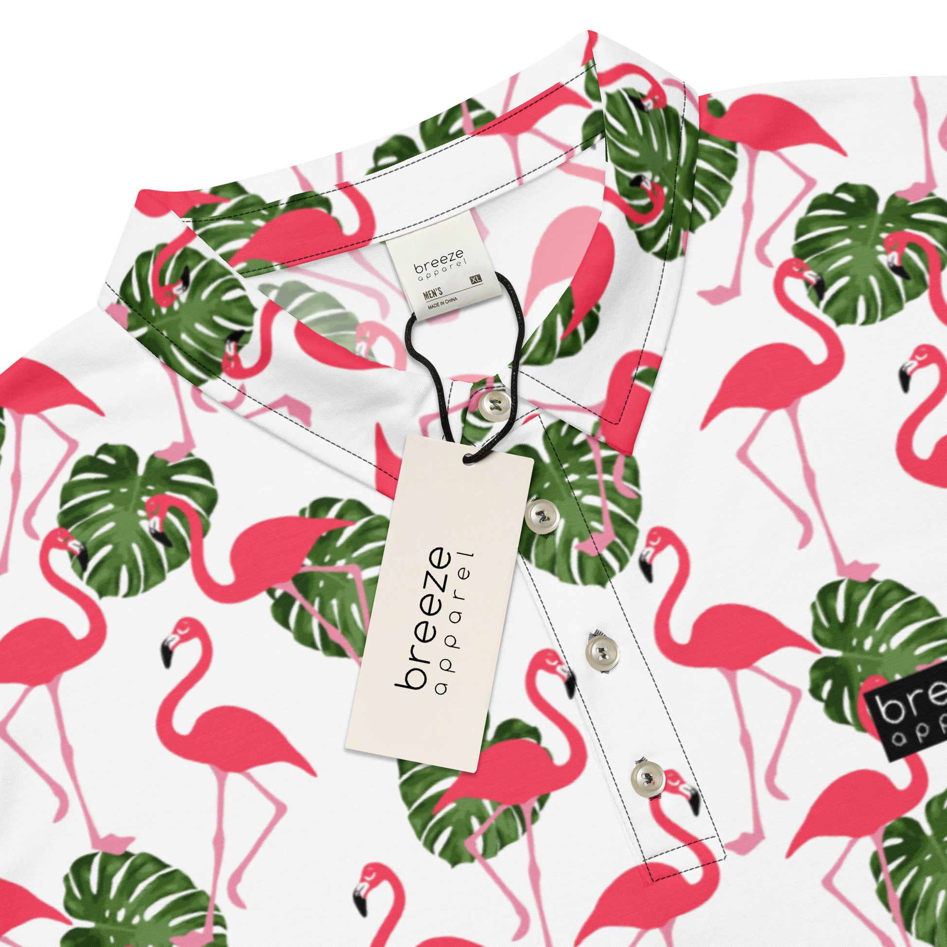 Polo with pattern of pink flamingos and green palm leaves set on a white background. Sleeves are pink.