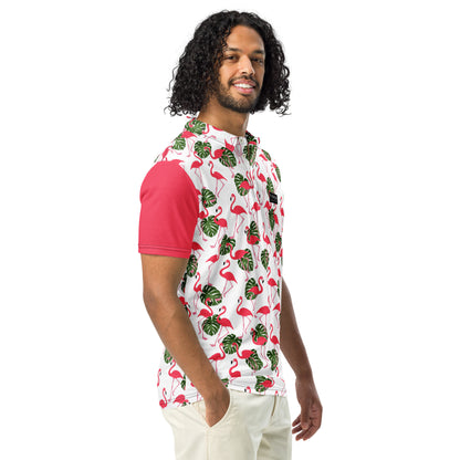 Man wearing polo with pattern of pink flamingos and green palm leaves set on a white background. Sleeves are pink.