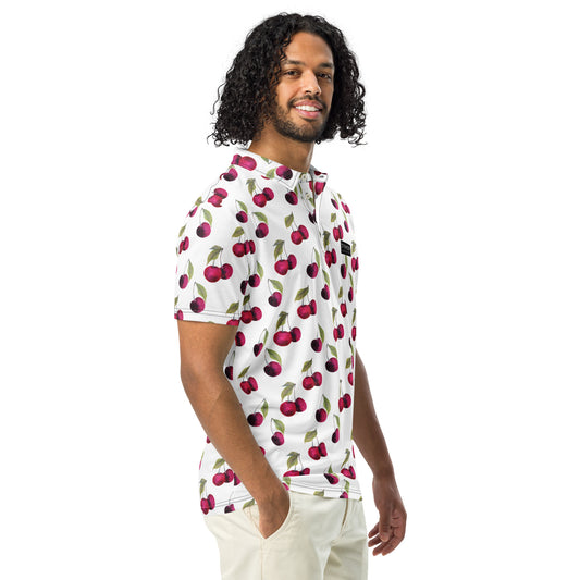 Man wearing polo with pattern of cherries set on a white background.