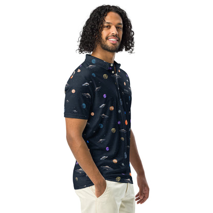 Man wearing polo shirt with pattern of UFOs and planets in space.