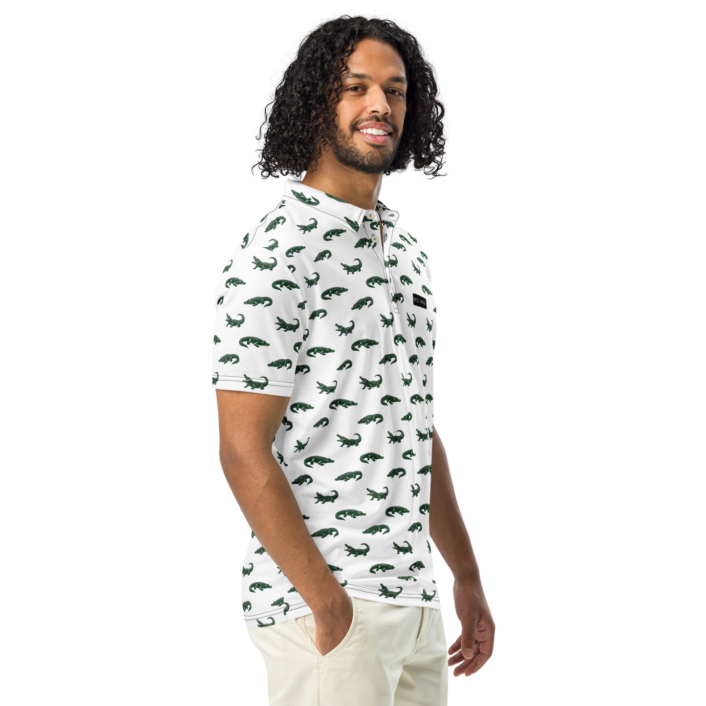 Man wearing white polo with pattern of green alligators.