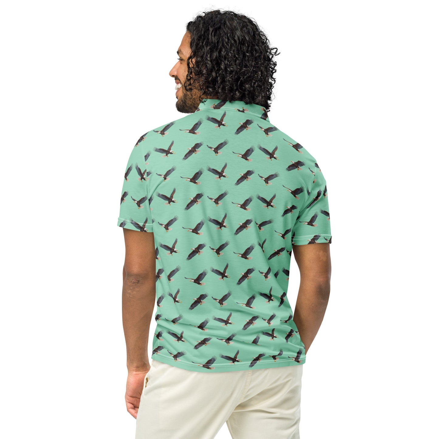 Man wearing green polo shirt with pattern of bald eagles.