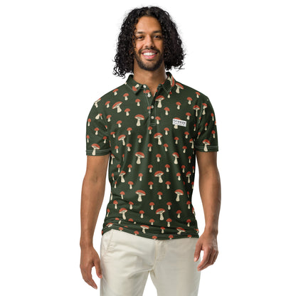 Man wearing polo with pattern of white-and-red mushrooms set on a dark-green background.