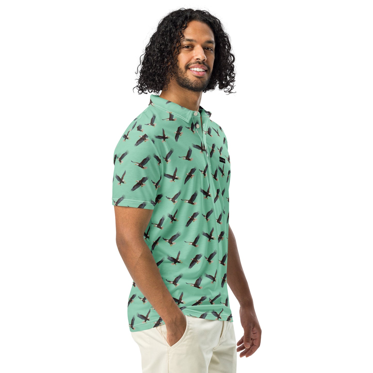 Man wearing green polo shirt with pattern of bald eagles.
