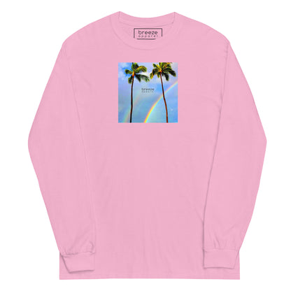 Light-pink long-sleeved shirt with a graphic of palm trees, rainbow, and a clear blue sky in the background. A small, black 'breeze apparel' logo is between the trees.