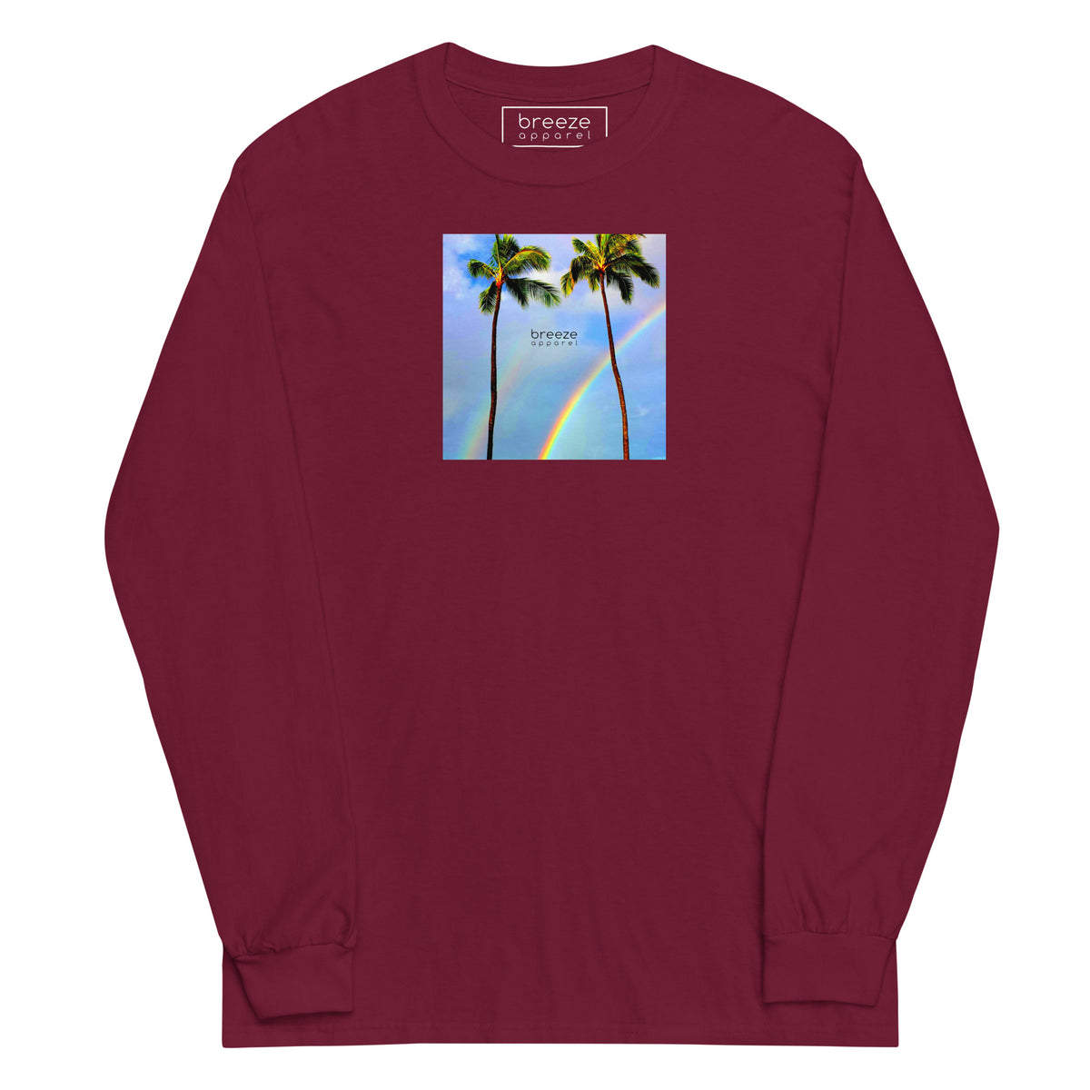 Maroon long-sleeved shirt with a graphic of palm trees, rainbow, and a clear blue sky in the background. A small, black 'breeze apparel' logo is between the trees.