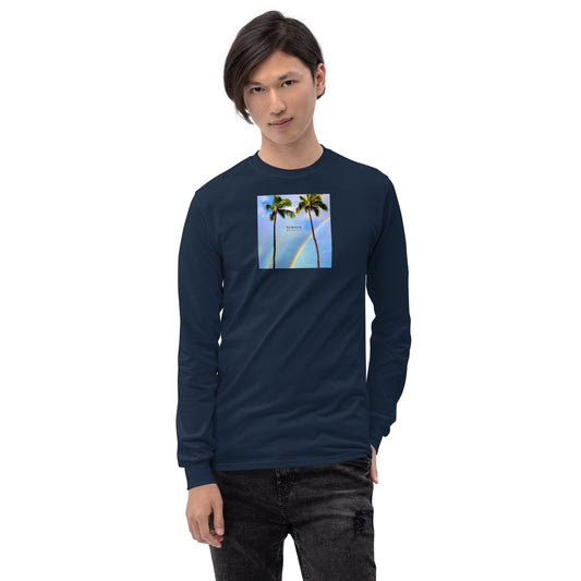 Man wearing navy long-sleeved shirt with a graphic of palm trees, rainbow, and a clear blue sky in the background. A small, black 'breeze apparel' logo is between the trees.