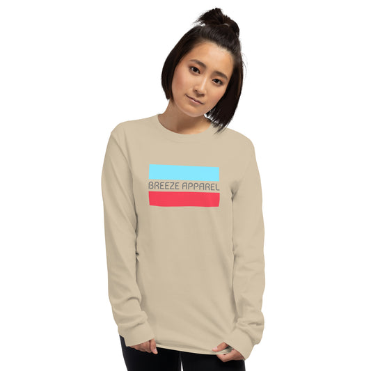 Woman wearing sand long-sleeved shirt with gray 'Breeze Apparel' logo between horizontal bars, the top being light blue and the bottom being red.