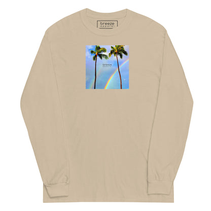Sand long-sleeved shirt with a graphic of palm trees, rainbow, and a clear blue sky in the background. A small, black 'breeze apparel' logo is between the trees.