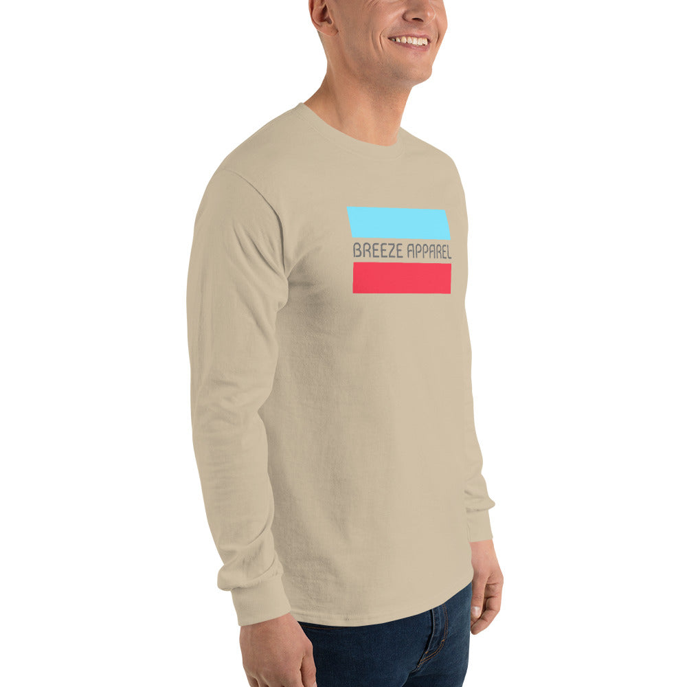Man wearing sand long-sleeved shirt with gray 'Breeze Apparel' logo between horizontal bars, the top being light blue and the bottom being red.