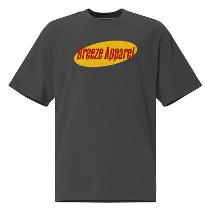 Gray t-shirt with graphic of red lettering set over yellow oval.