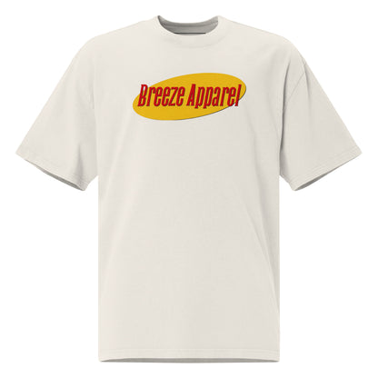 White t-shirt with graphic of red lettering set over yellow oval.