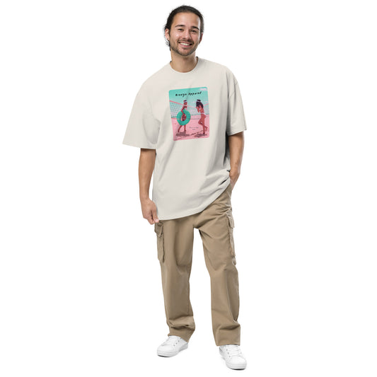 Man wearing white, oversized t-shirt with graphic of two women on beach.