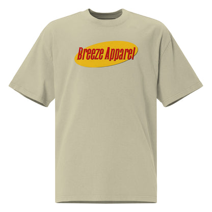 Green t-shirt with graphic of red lettering set over yellow oval.