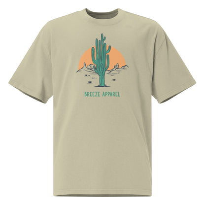 Green t-shirt with graphic of cactus and sunset.