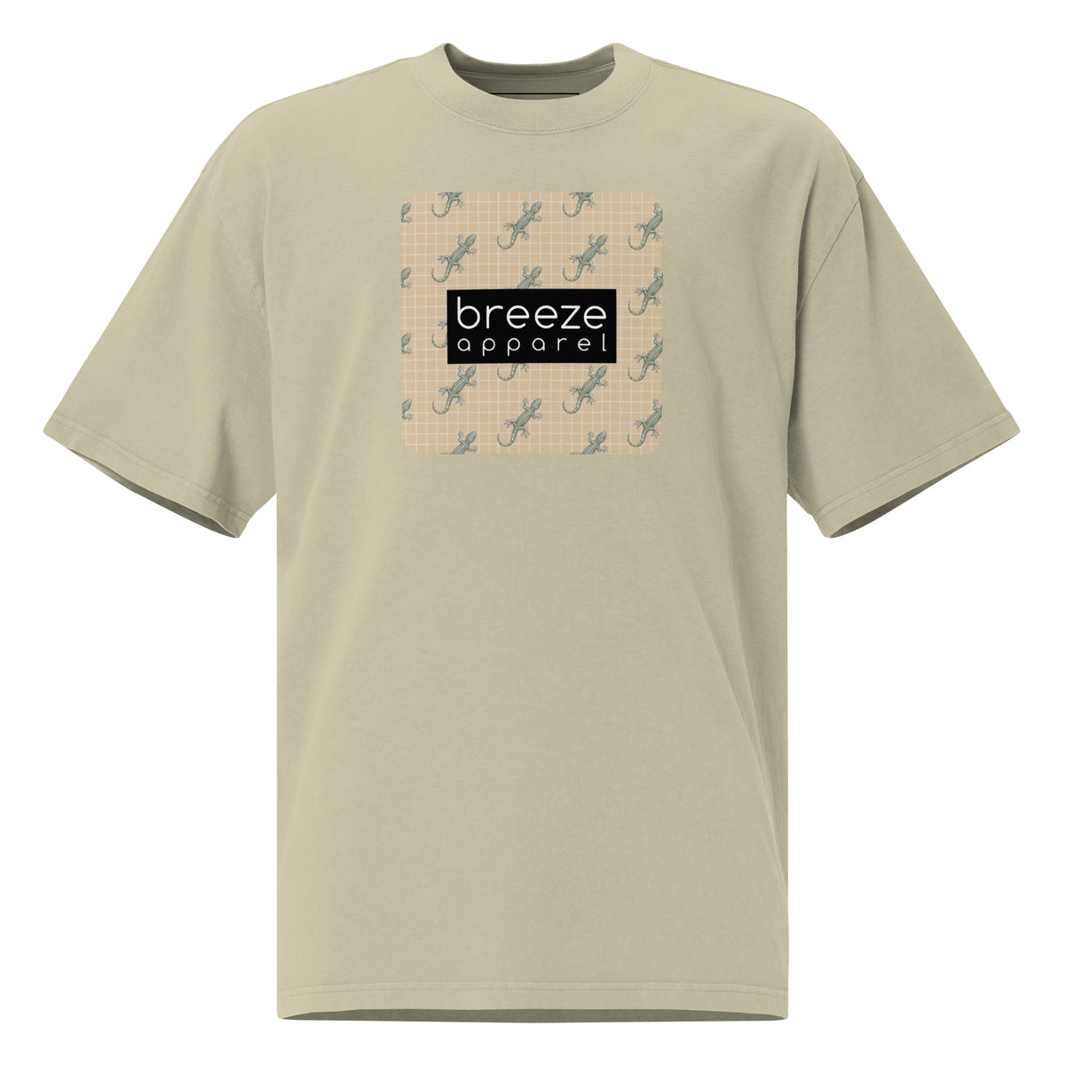 Green t-shirt with square over chest that contains pattern of green geckos set on beige background, overlaid with black, rectangular logo with white lettering.