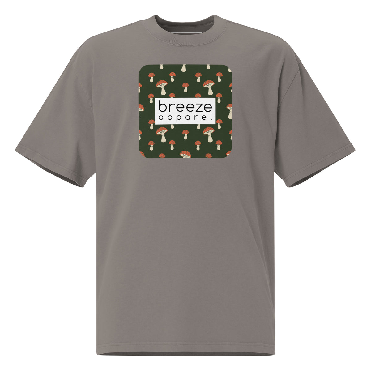 Gray t-shirt with square graphic of mushrooms on a green background and overlaid with white, rectangular logo.