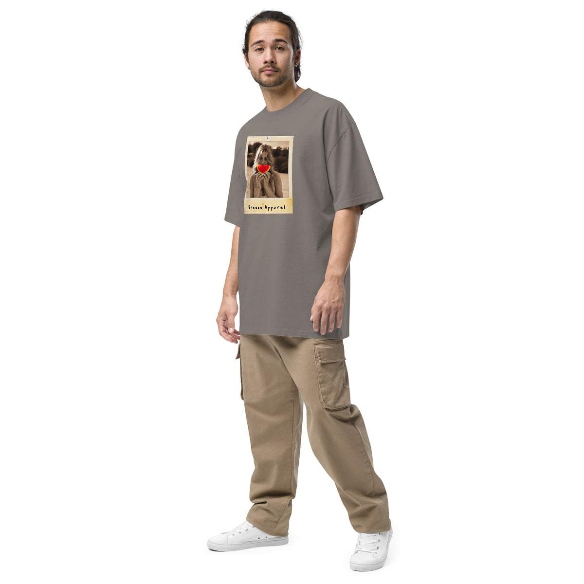 Man wearing gray t-shirt with graphic of woman holding watermelon slice in front of her mouth.