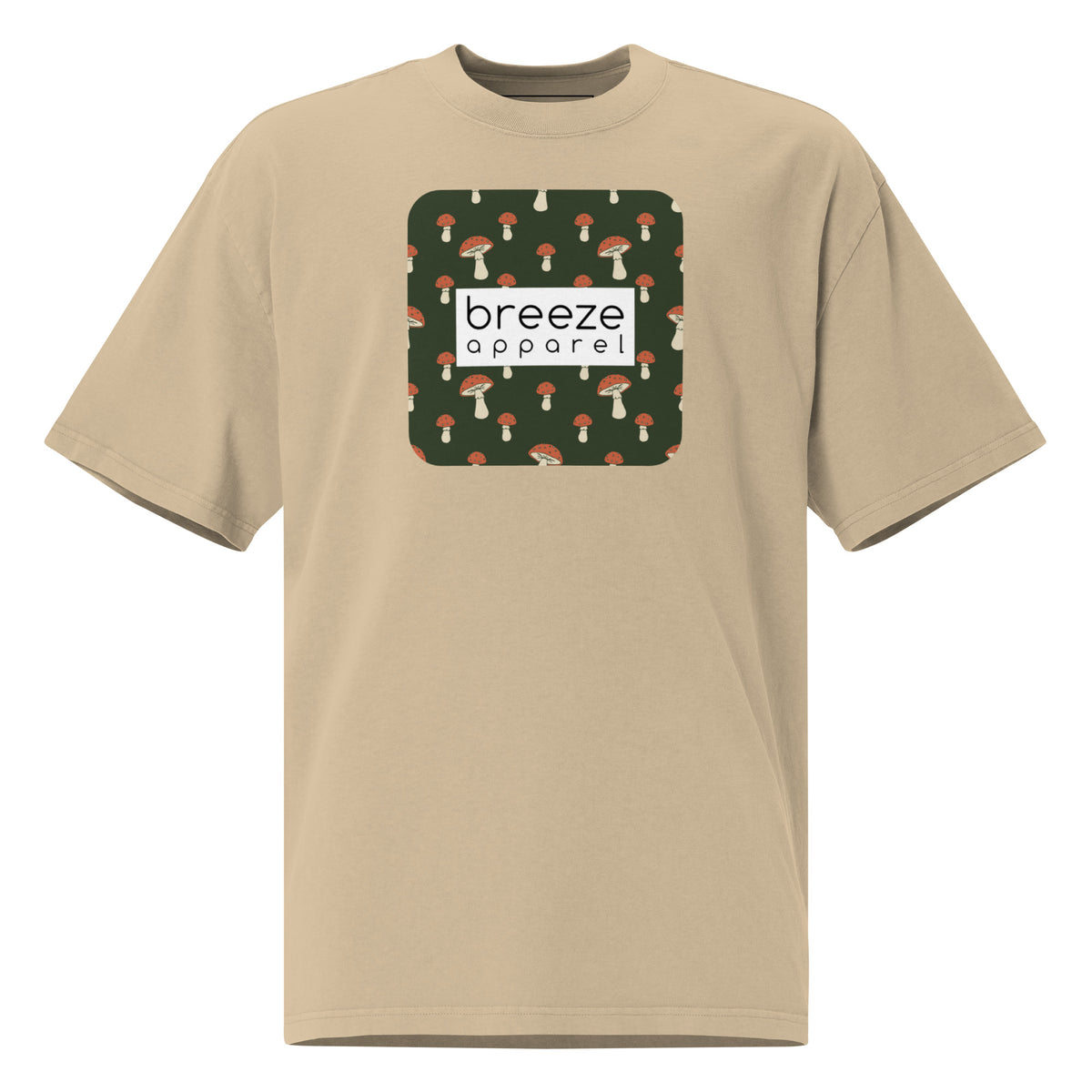 Tan t-shirt with square graphic of mushrooms on a green background and overlaid with white, rectangular logo.