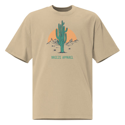 Tan t-shirt with graphic of cactus and sunset.