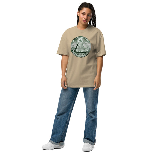 Woman wearing beige t-shirt with graphic resembling pyramid on US one-dollar bill.