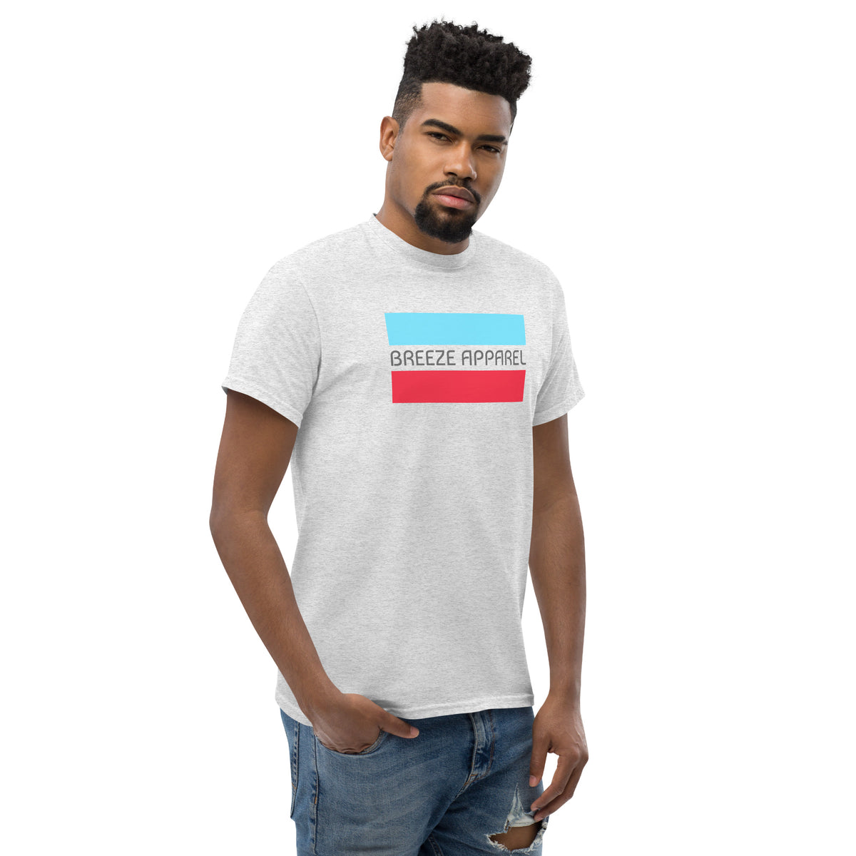 Man wearing ash-gray t-shirt with gray 'Breeze Apparel' logo between horizontal bars, the top being light blue and the bottom being red