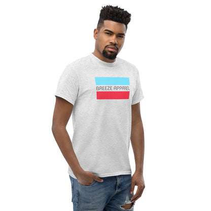 Man wearing ash-gray t-shirt with gray 'Breeze Apparel' logo between horizontal bars, the top being light blue and the bottom being red