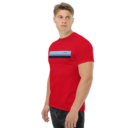 Man wearing red t-shirt with horizontal blue, red, white, and navy stripe with small black 'breeze apparel' logo.