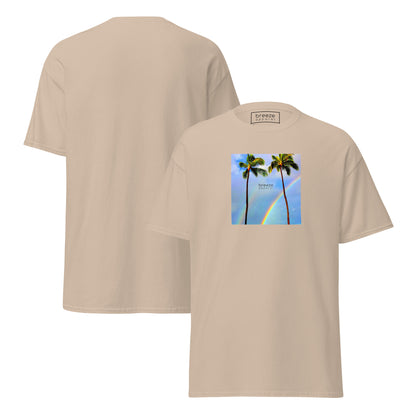 Sand t-shirt with a graphic of palm trees, rainbow, and a clear blue sky in the background. A small, black 'breeze apparel' logo is between the trees. Plain backside also shown.