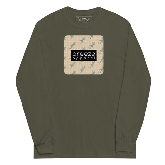 Green, long-sleeved shirt with square over chest that contains pattern of green geckos set on beige background, overlaid with black, rectangular logo with white lettering.