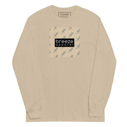 Beige, long-sleeved shirt with square over chest that contains pattern of green geckos set on beige background, overlaid with black, rectangular logo with white lettering.
