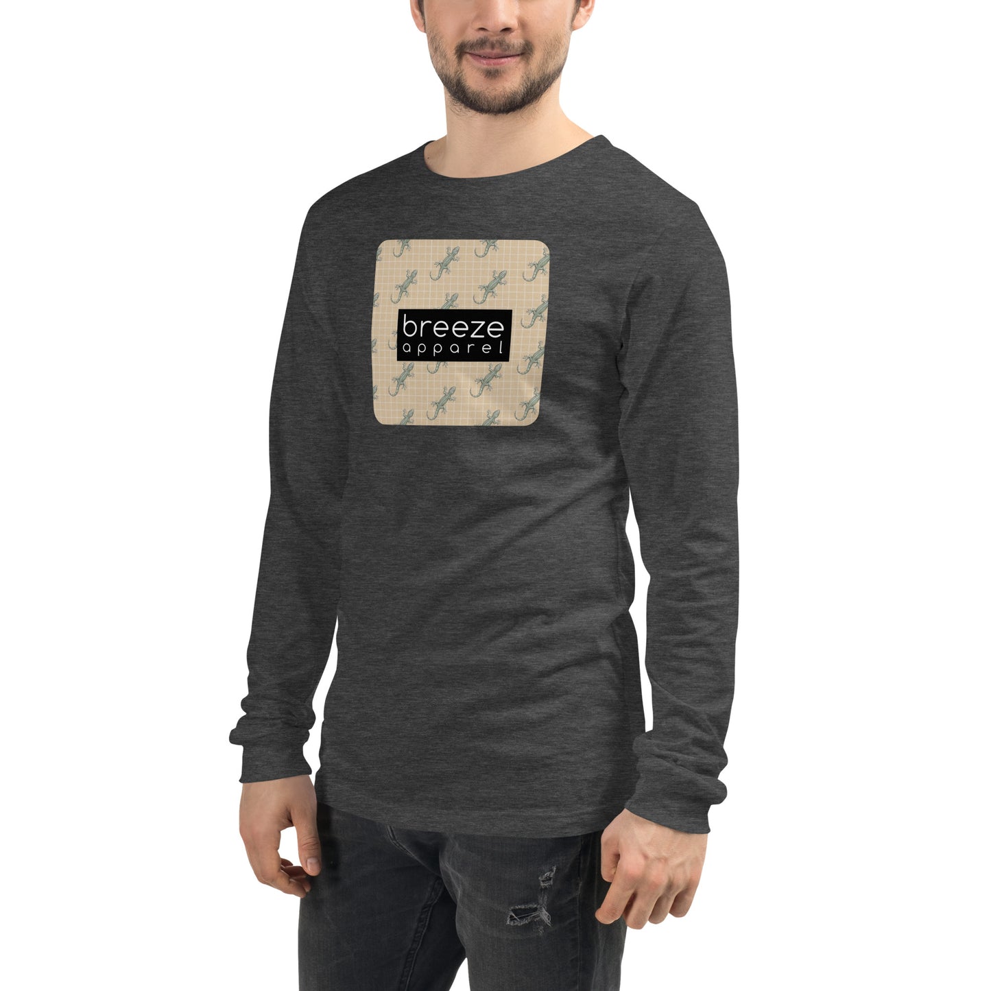 Man wearing gray, long-sleeved shirt with square over chest that contains pattern of green geckos set on beige background, overlaid with black, rectangular logo with white lettering.