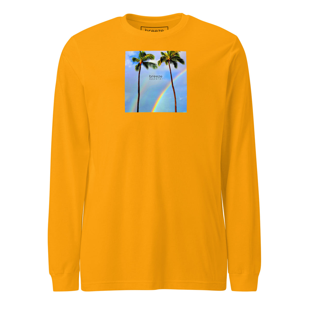 Gold long-sleeved shirt with a graphic of palm trees, rainbow, and a clear blue sky in the background. A small, black 'breeze apparel' logo is between the trees.