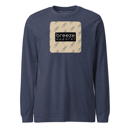 Navy, long-sleeved shirt with square over chest that contains pattern of green geckos set on beige background, overlaid with black, rectangular logo with white lettering.