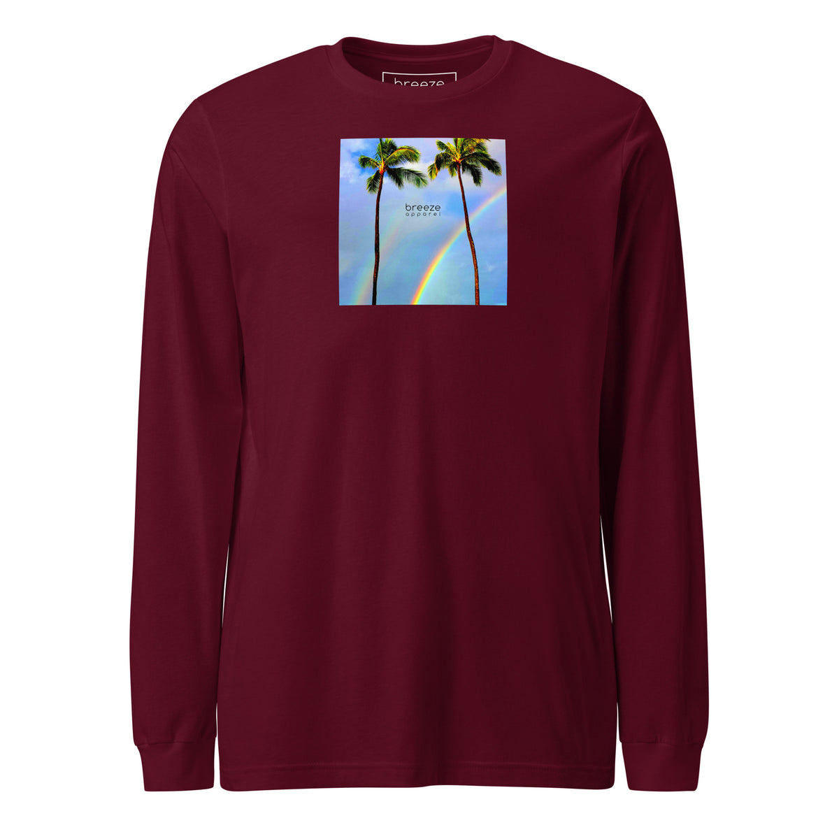 Maroon long-sleeved shirt with a graphic of palm trees, rainbow, and a clear blue sky in the background. A small, black 'breeze apparel' logo is between the trees.