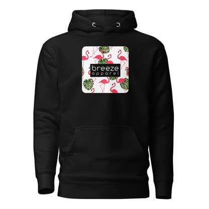 Black hoodie with graphic of flamingos and green palm leaves set on a white background and overlaid with a black, rectangular logo.