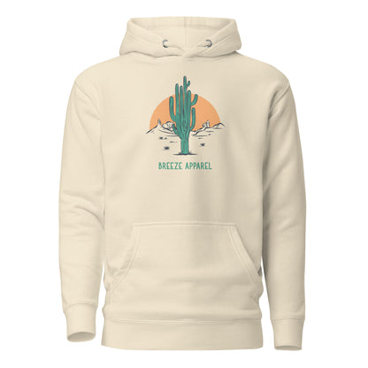 Beige hoodie with graphic of cactus and sunset.