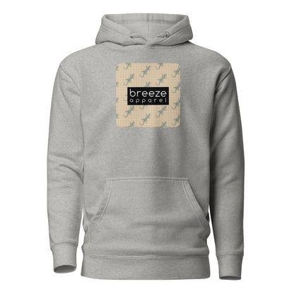 Gray hoodie with square over chest that contains pattern of green geckos set on beige background, overlaid with black, rectangular logo with white lettering.
