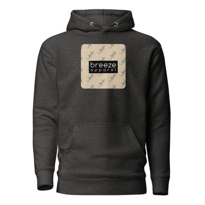Gray hoodie with square over chest that contains pattern of green geckos set on beige background, overlaid with black, rectangular logo with white lettering.