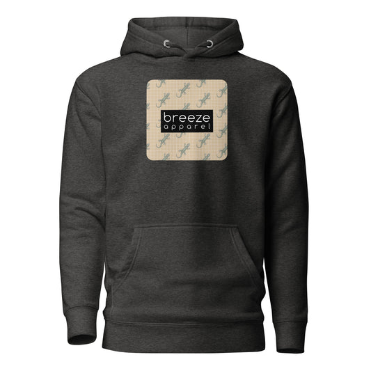 Gray hoodie with square over chest that contains pattern of green geckos set on beige background, overlaid with black, rectangular logo with white lettering.