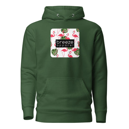 Green hoodie with graphic of flamingos and green palm leaves set on a white background and overlaid with a black, rectangular logo.