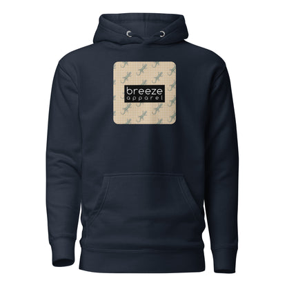 Navy hoodie with square over chest that contains pattern of green geckos set on beige background, overlaid with black, rectangular logo with white lettering.
