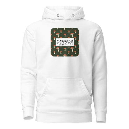 White hoodie with graphic of mushrooms set on a green background and overlaid with a white, rectangular logo.