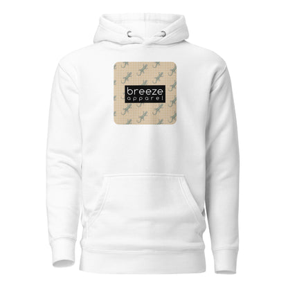 White hoodie with square over chest that contains pattern of green geckos set on beige background, overlaid with black, rectangular logo with white lettering.