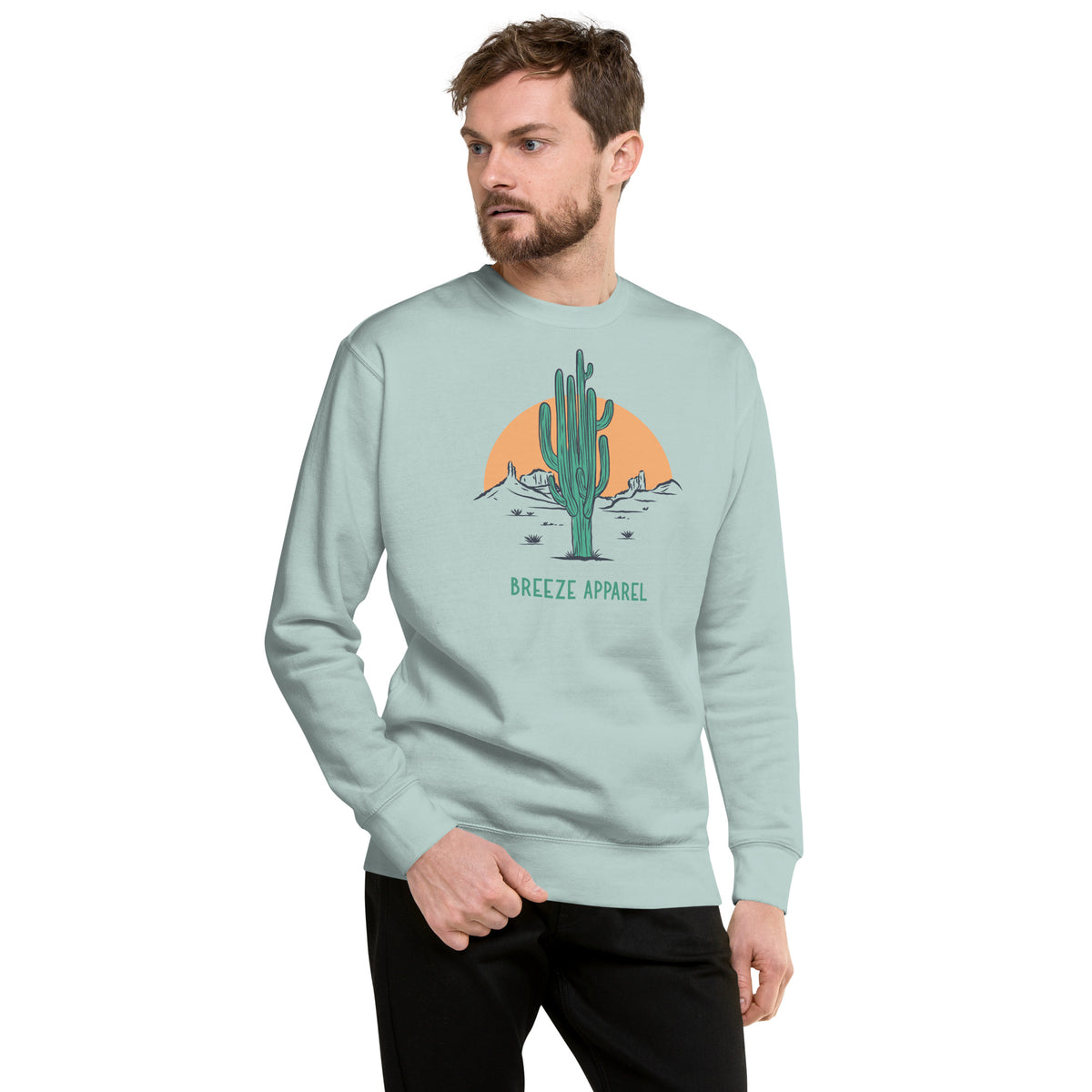 Man wearing silver-blue sweatshirt with graphic of cactus and sun.