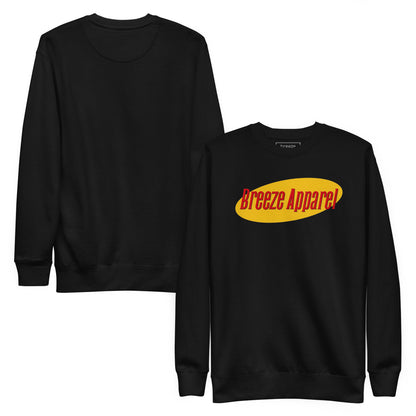 Black sweatshirt with graphic of red lettering set on a yellow oval. Plain backside also shown.
